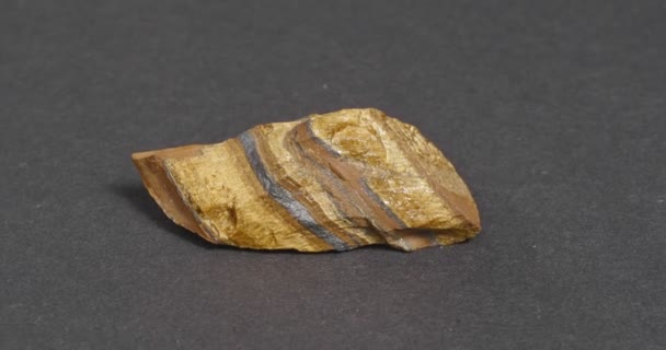 Mineral tiger eye on a dark background. — Stock Video