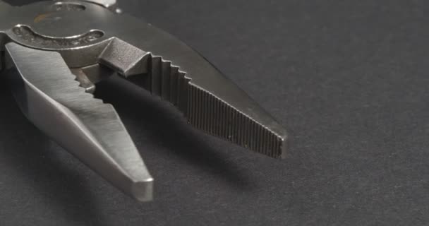 Pliers close-up on a dark background. Repair tools. — Stock Video