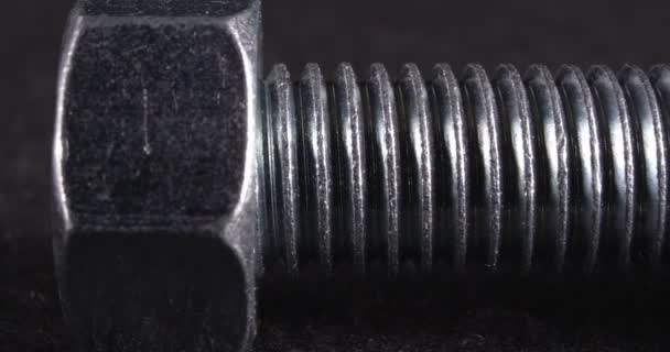 Bolt close-up on a dark background. Fastener. — Stock Video
