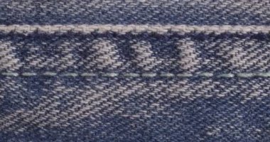 Kotun dokusu yakın plan. Kot pantolon makrosu. Yakın çekim dikiş..