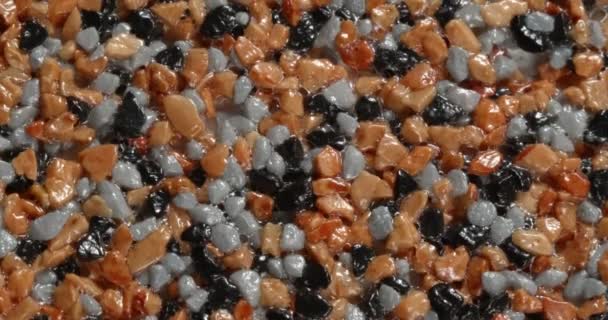 Close-up texture of fine marble chips. Brown and grey and black color. — Stockvideo