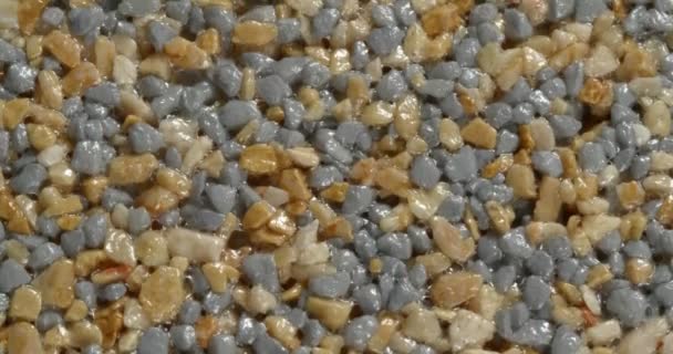 Close-up texture of fine marble chips. Small fraction. Ocher and blue color. — Stock Video