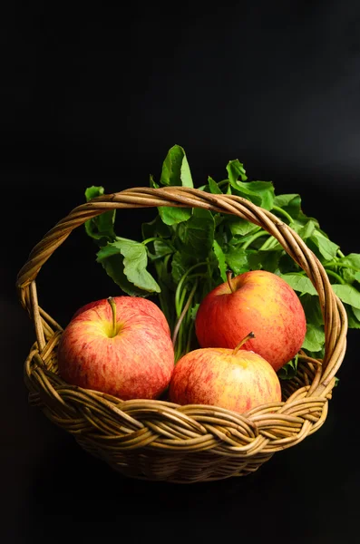 Manzana y asiática en cesta sobre fondo negro — Foto de Stock