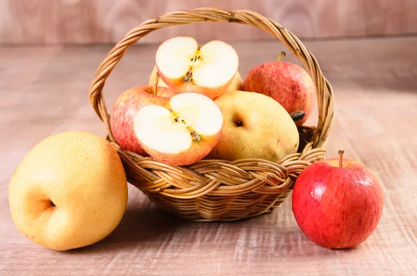 Apples in basket on a wood background — Stock Photo, Image