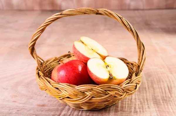 Apples in basket on a wood background — Stock Photo, Image