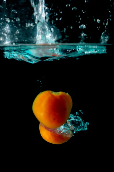 Tomato water splash on black background Stock Image