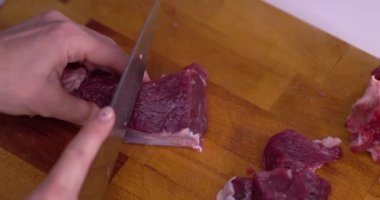 Meat cut into cubes, slow motion.
