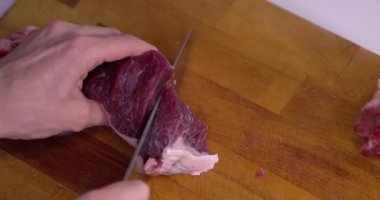 Meat cut into cubes, slow motion.