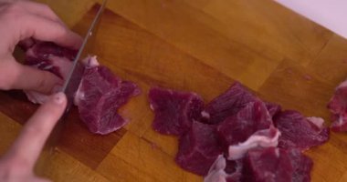 Meat cut into cubes, slow motion.