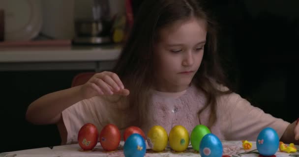 Girl Glues Decorative Stickers Easter Eggs Folds Them Easter Eggs — 图库视频影像