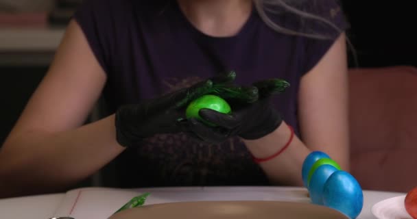 Girl Paints Easter Eggs Her Hands Black Gloves — ストック動画
