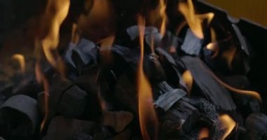 Close-up coal burn in the fire in slow motion. Coal is starting to burn. Super Slow motion video.