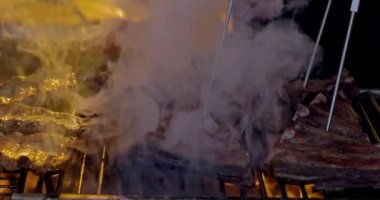 Grilled pork ribs on a flaming grill  with temperature sensors. Ribs on flaming grill barbecued.