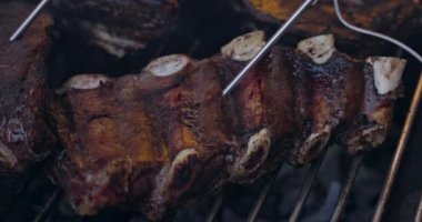 Grilled pork ribs on a flaming grill  with temperature sensors. Ribs on flaming grill barbecued.