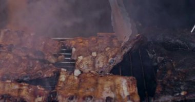 Grilled pork ribs on a flaming grill  with temperature sensors. Ribs on flaming grill barbecued.