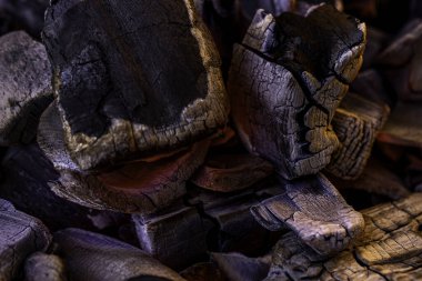 Glowing Hot Charcoal Background Texture. Red hot coals in the grill close up. hot red coals among black ash, wallpapers for mobile devices, abstract.