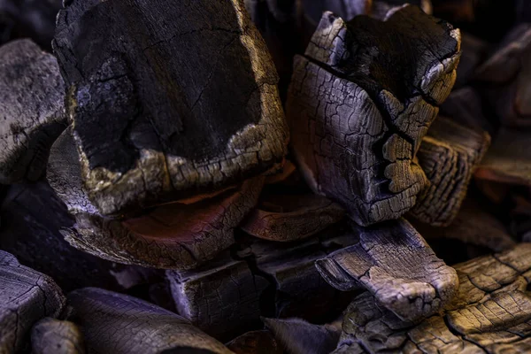 Glowing Hot Charcoal Background Texture. Red hot coals in the grill close up. hot red coals among black ash, wallpapers for mobile devices, abstract.