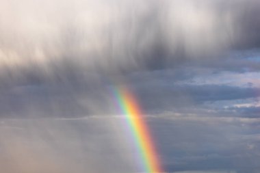 Rainbow colorful sunset on blue pink sky yellow clouds skyline. blue sky with white clouds - perfect for sky replacement
