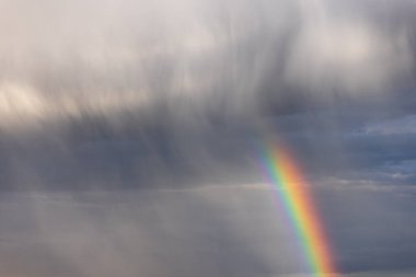 Rainbow colorful sunset on blue pink sky yellow clouds skyline. blue sky with white clouds - perfect for sky replacement