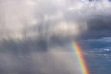 Rainbow colorful sunset on blue pink sky yellow clouds skyline. blue sky with white clouds - perfect for sky replacement