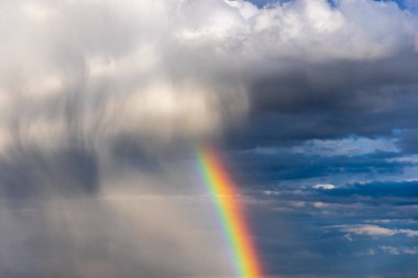 Rainbow colorful sunset on blue pink sky yellow clouds skyline. blue sky with white clouds - perfect for sky replacement