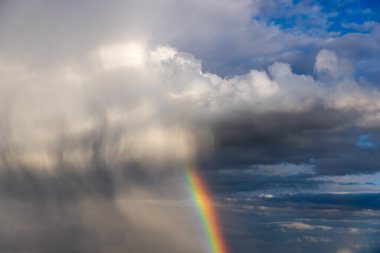 Rainbow colorful sunset on blue pink sky yellow clouds skyline. blue sky with white clouds - perfect for sky replacement