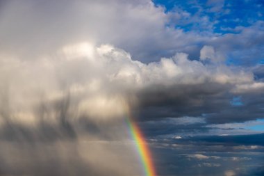 Rainbow colorful sunset on blue pink sky yellow clouds skyline. blue sky with white clouds - perfect for sky replacement