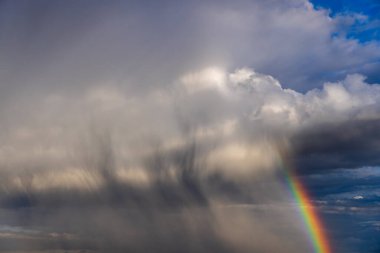 Rainbow colorful sunset on blue pink sky yellow clouds skyline. blue sky with white clouds - perfect for sky replacement
