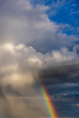 Rainbow colorful sunset on blue pink sky yellow clouds skyline. blue sky with white clouds - perfect for sky replacement