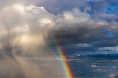 Rainbow colorful sunset on blue pink sky yellow clouds skyline. blue sky with white clouds - perfect for sky replacement