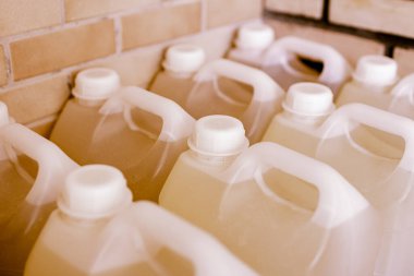 Stack of white plastic canisters with fuel