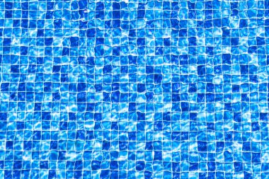 Outdoor photo of a mosaic-patterned residential swimming pool. Swimming pool with steps.