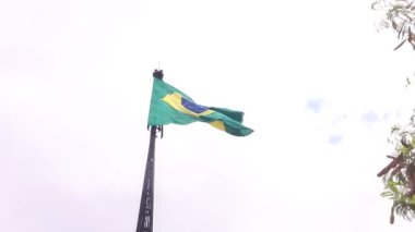 Brazil, Federal District - December 05, 2021: Mast and pavilion of the square of the three powers. The national Brazilian flag waving in the wind on a cloudy day. 