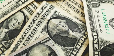 Folded dollar bills on the table. Money background, us currency (USD). Close-up photo.