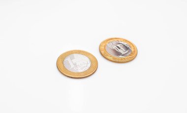 Two 1 Real coins isolated on white background. Front side and back side.