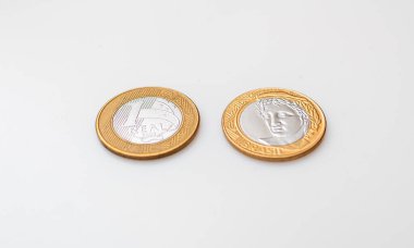 Two 1 Real coins isolated on white background. Front side and back side.