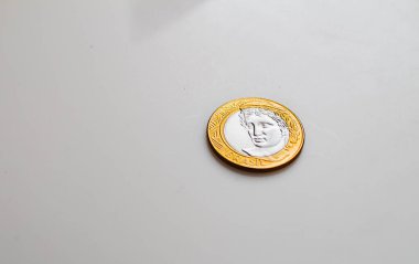 Brazilian Real - BRL. Dinheiro, Brasil, Reais, moeda. Photograph of a brazilian coins on a brazilian banknotes.