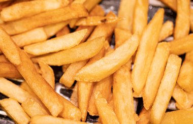 Pile of french fries potatoes, close-up view