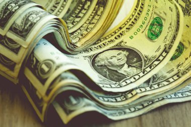 One dollar banknote closeup shot in low light environment. Economy and finance.