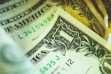 One dollar banknote closeup shot in low light environment. Economy and finance.