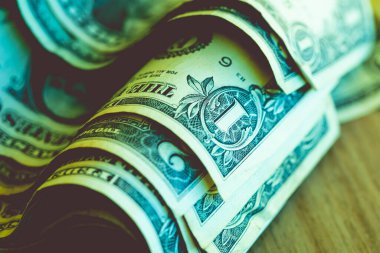 One dollar banknote closeup shot in low light environment. Economy and finance.