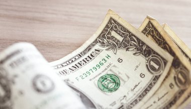 One dollar banknote closeup shot in low light environment. Economy and finance.