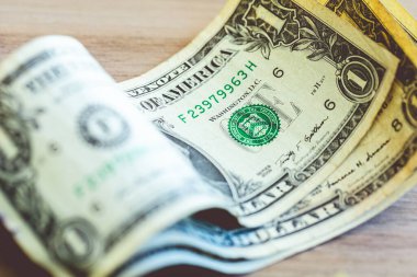 One dollar banknote closeup shot in low light environment. Economy and finance.