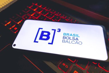 Brasilia, Federal District - Brazil. August, 19, 2022: Phone screen with B3 - Brazilian Stock Exchange company logo