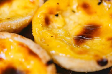 Pastel de Belm or Pastel de Nata. Pastis de Belm on a wooden board ready to eat. Traditional sweet from Portugal.