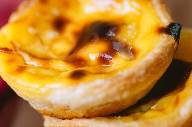 Pastel de Belm or Pastel de Nata. Pastis de Belm on a wooden board ready to eat. Traditional sweet from Portugal.