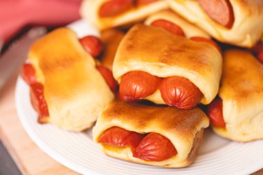 Hot dog baked with bread dough (Syrian hot dog) or sausage roll in bread dough. Traditional salted in Brazil. Brazilian food. Hot dog.