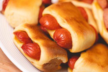 Hot dog baked with bread dough (Syrian hot dog) or sausage roll in bread dough. Traditional salted in Brazil. Brazilian food. Hot dog.