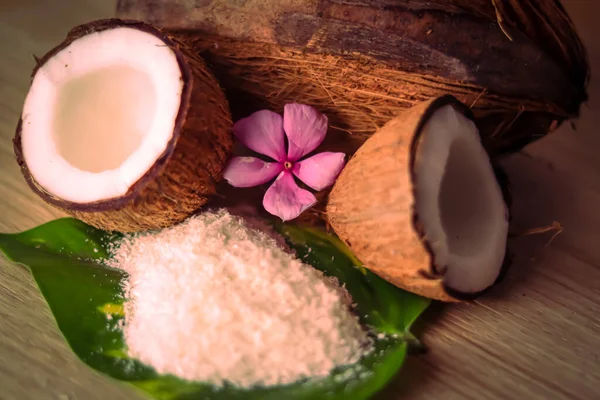 Coconut and grounded coconut flakes,homemade fresh hand traditional hand pressed coconut milk in small glass,,selective focus on subject,