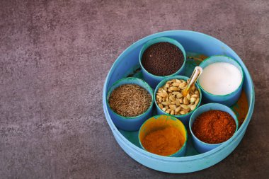 Fotokopi alanı arka planı, kakule, zerdeçal, kırmızı biber tozu, tuz, hardal tohumu, kimyon, seçici odak noktası olan Hint baharatları.